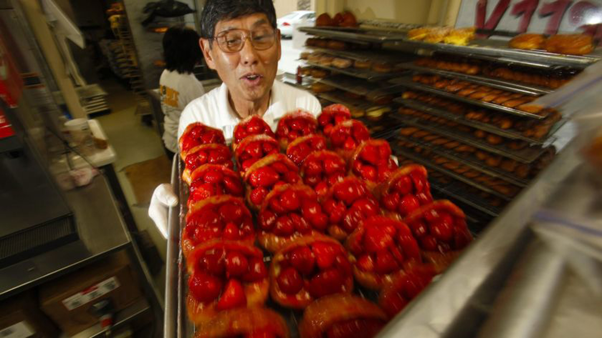 The Donut Man founder Jim Nakano with a tray of his strawberry donuts in 2011. The beloved shop will expand to downtown L.A.'s Grand Central Market next year.(Credit: Mark Boster / Los Angeles Times)