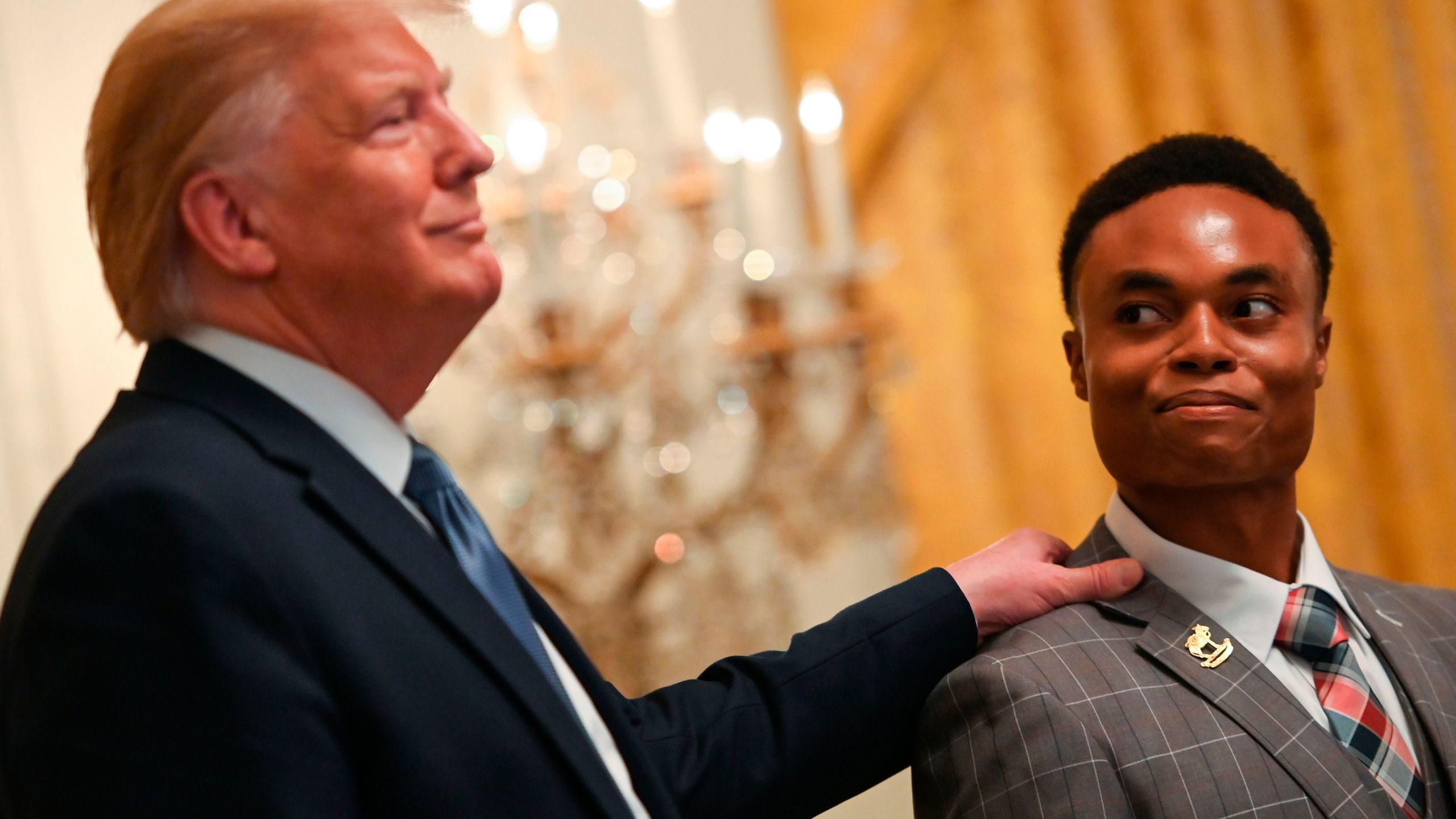 Ben Okereke (R), President of TPUSA Georgia State University looks to President Donald Trump as he speaks during the Young Black Leadership Summit at the White House in Washington, Friday, Oct. 4, 2019. (Credit: ANDREW CABALLERO-REYNOLDS/AFP via Getty Images)