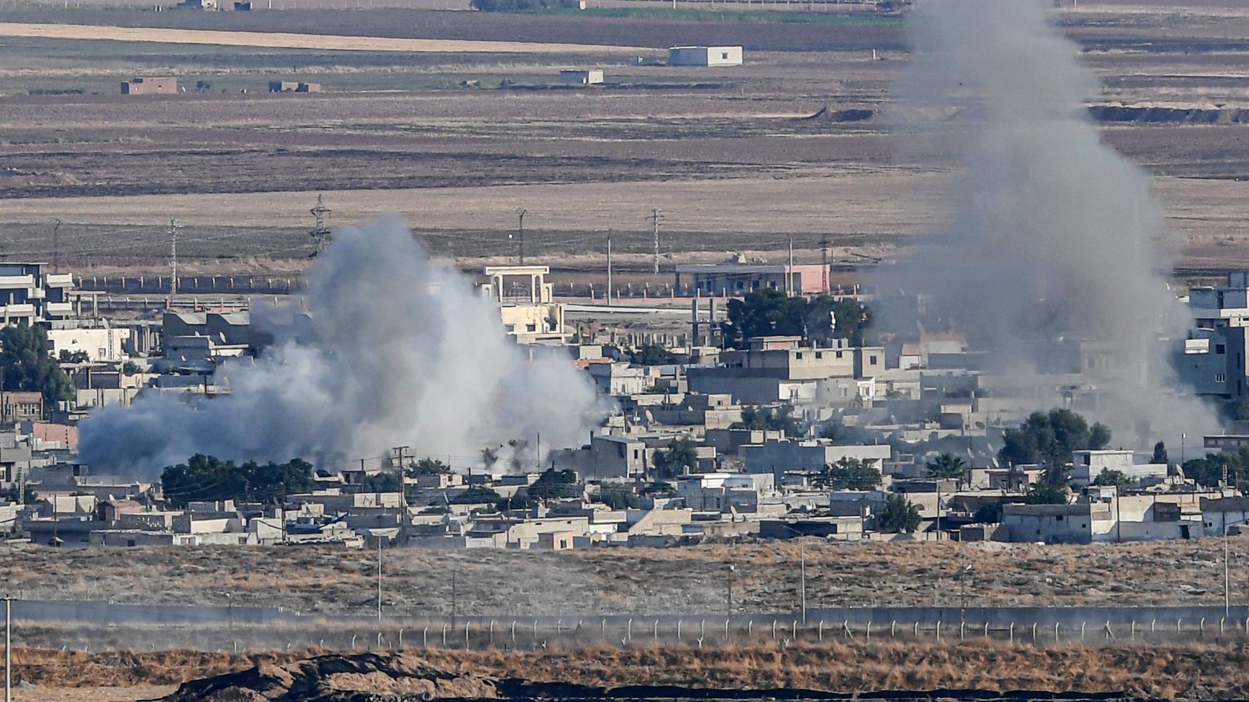 This picture taken on Oct. 15, 2019, from the Turkish side of the border at Ceylanpinar district in Sanliurfa shows smoke rising from the Syrian town of Ras al-Ain on the first week of Turkey's military operation against Kurdish forces. (Credit: OZAN KOSE/AFP via Getty Images)