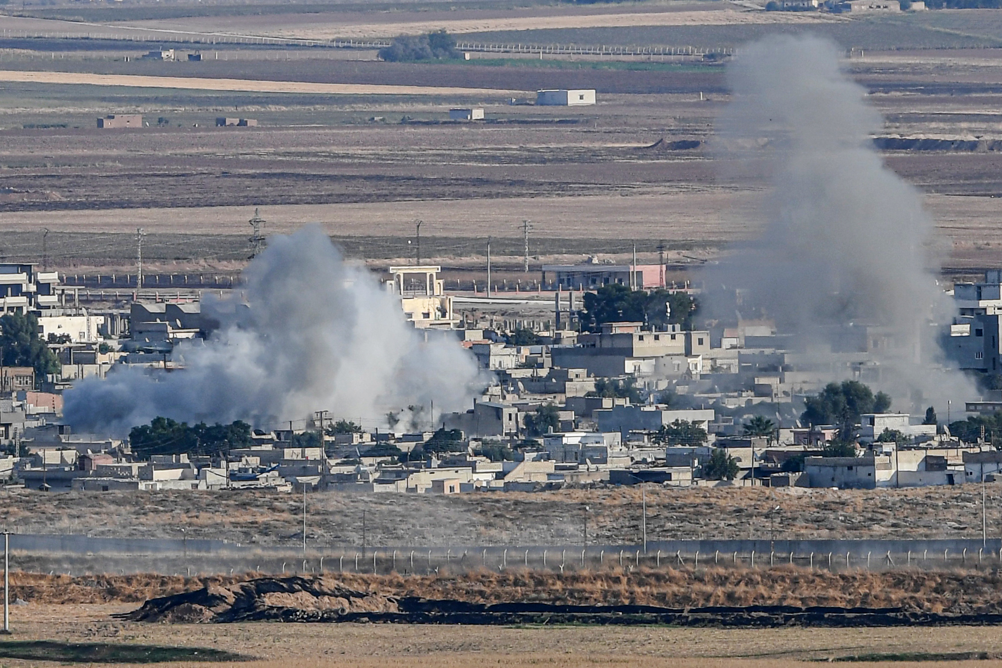 This picture taken on Oct. 15, 2019, from the Turkish side of the border at Ceylanpinar district in Sanliurfa shows smoke rising from the Syrian town of Ras al-Ain on the first week of Turkey's military operation against Kurdish forces. (Credit: OZAN KOSE/AFP via Getty Images)