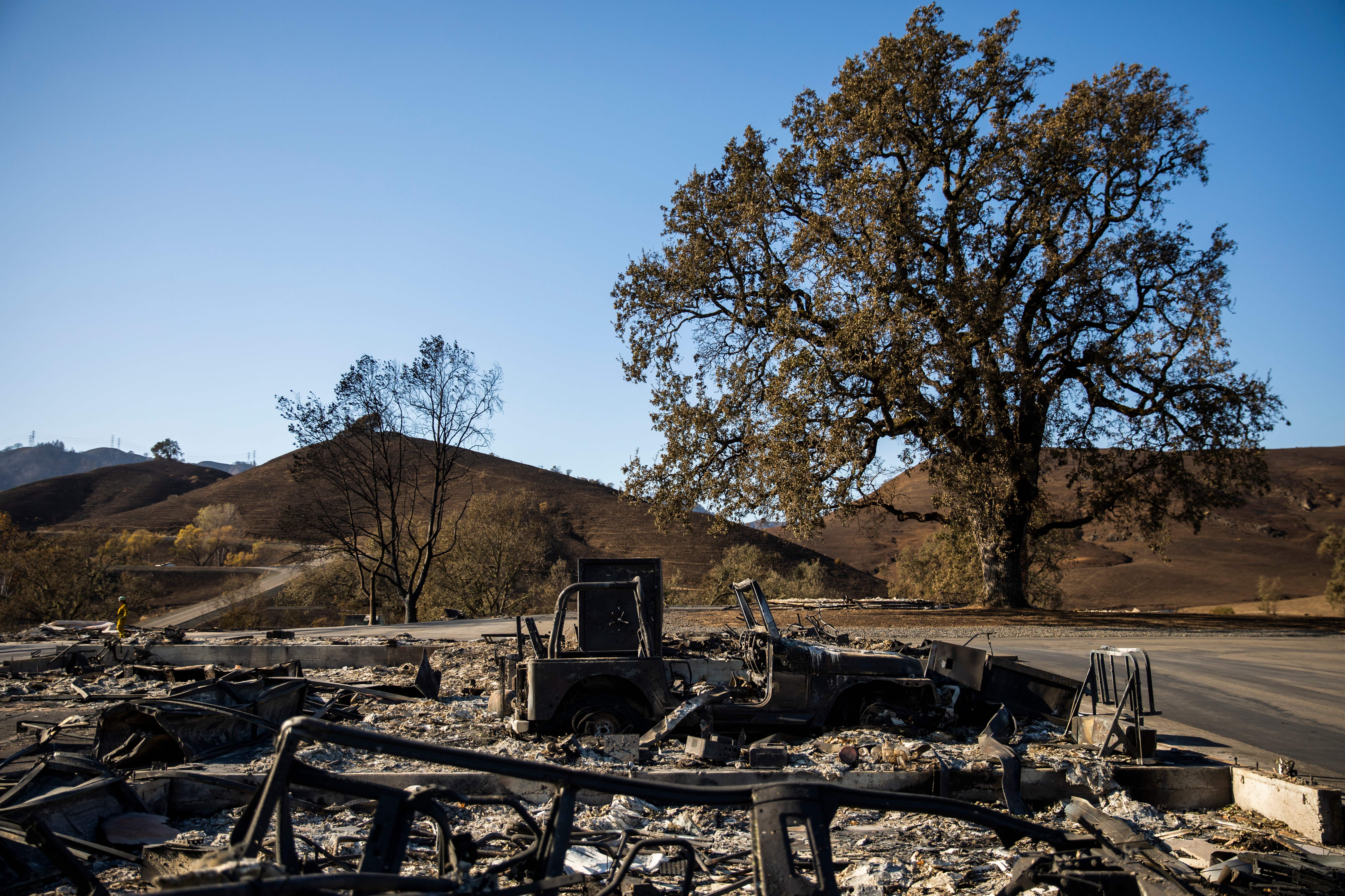 A burned vehicle sits on a property devastated by the Kincade Fire off Briggs Ranch Road in Kellogg on Oct. 31, 2019. (Credit: PHILIP PACHECO/AFP via Getty Images)