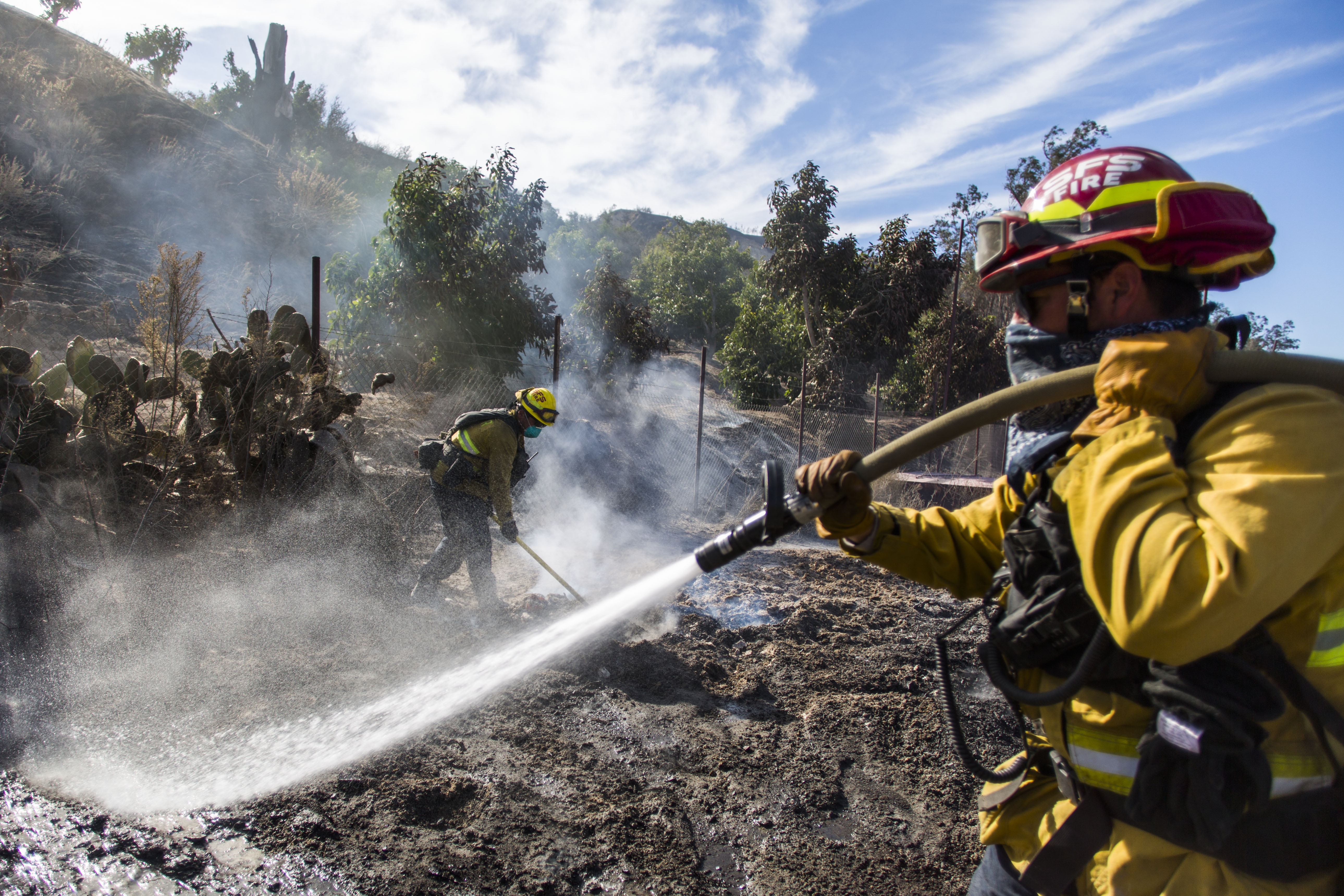 Firefighters from Santa Fe Springs battle to control hotspots during the Maria Fire in Santa Paula area on Nov. 2, 2019. (Credit: Apu Gomes / AFP / Getty Images)