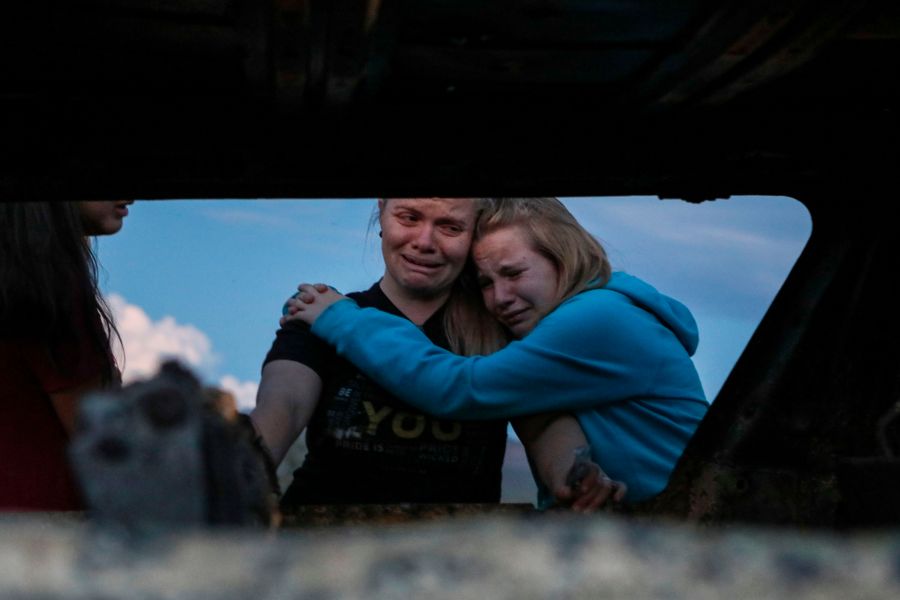 Members of the LeBaron family mourn while viewing the burned car where their relatives were killed and burned during an ambush in Bavispe, Sonora mountains, Mexico, on Nov. 5, 2019. (Credit: Herika Martinez / AFP / Getty Images)