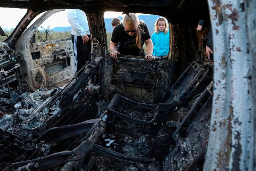 Members of the LeBaron family view the burned car where their relatives were killed and burned during an ambush in Bavispe, Sonora mountains, Mexico, on Nov. 5, 2019. (Credit: Herika Martinez / AFP / Getty Images)