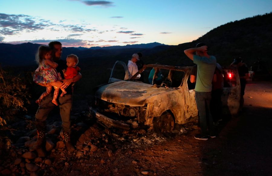 Members of the LeBaron family view the burned car where their relatives were killed and burned during an ambush in Bavispe, Sonora mountains, Mexico, on Nov. 5, 2019. (Credit: Herika Martinez / AFP / Getty Images)