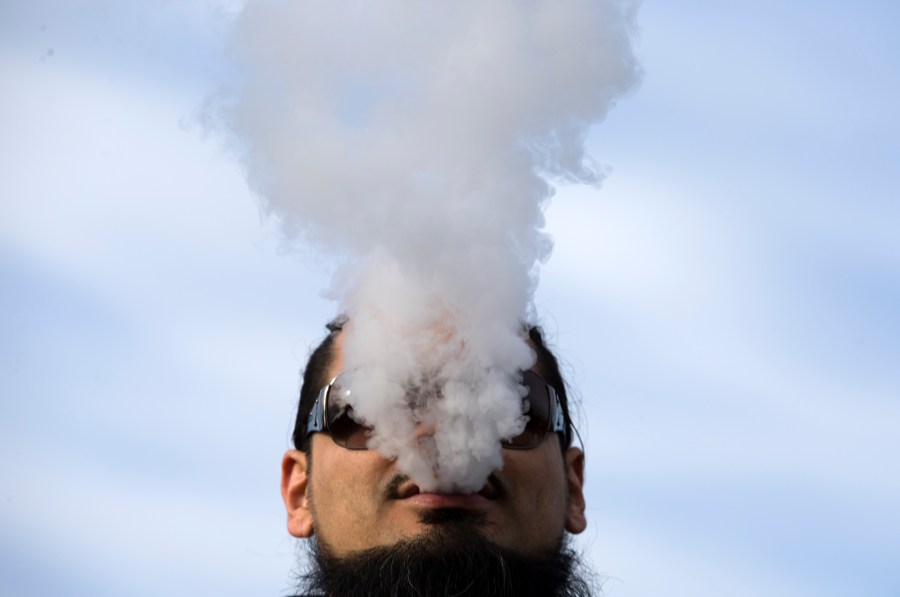 A demonstrator vapes during a rally outside the White House protesting a proposed vaping flavor ban on Nov. 9, 2019. (Credit: Jose Luis Magana / AFP / Getty Images)