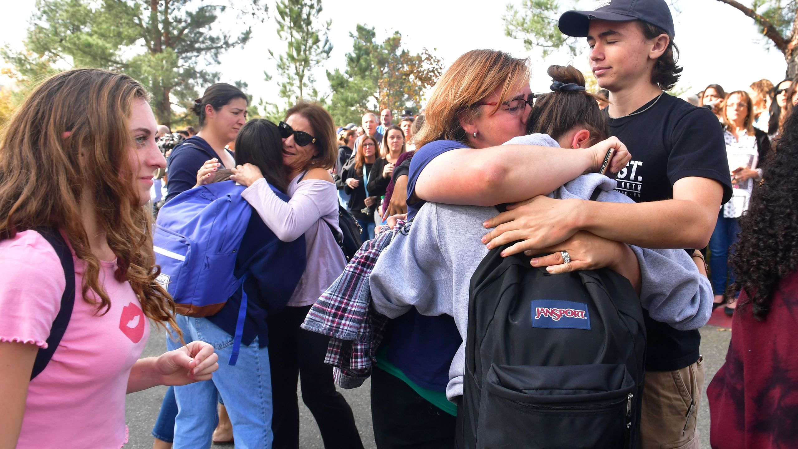 Grieving students from Saugus High School reunite with their parents at Central Park in Santa Clarita after a fatal school shooting on Nov. 14, 2019. (Credit: Frederic J. Brown / AFP / Getty Images)