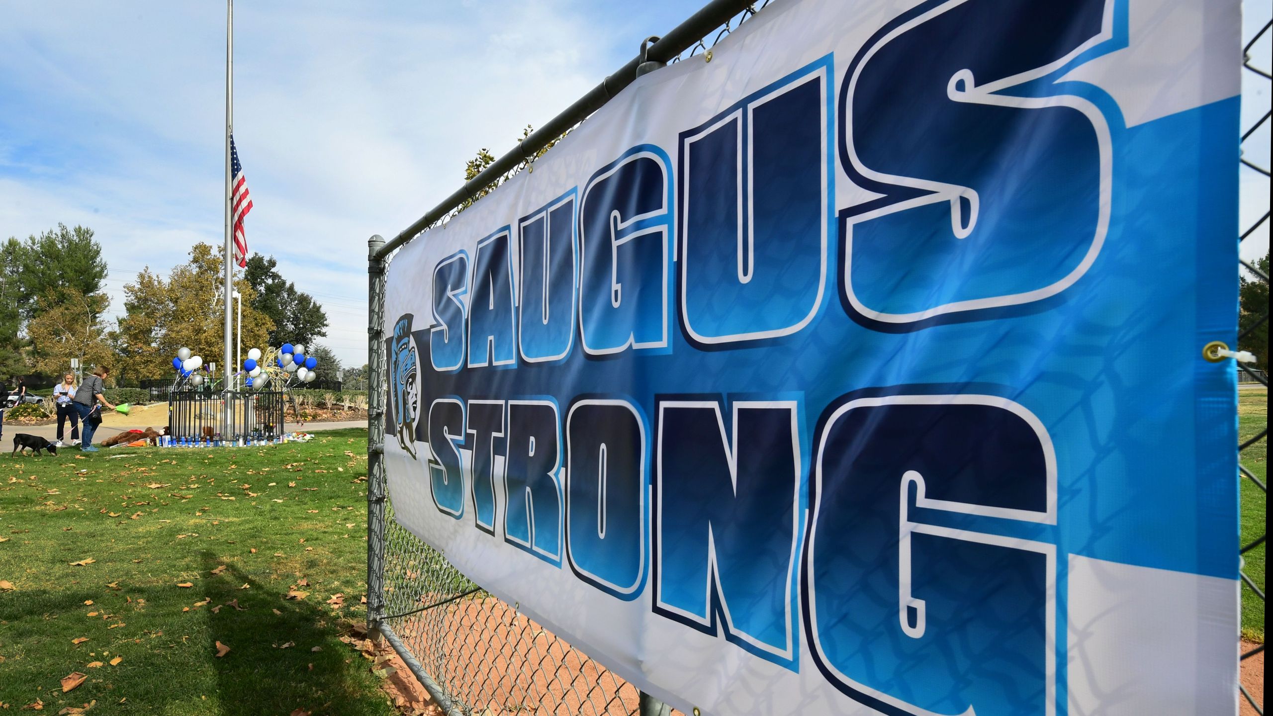 A sign reads "Saugus Strong" at a makeshift memorial in Central Park, near Saugus High School, Nov. 15, 2019 in Santa Clarita. (Credit: FREDERIC J. BROWN/AFP via Getty Images)