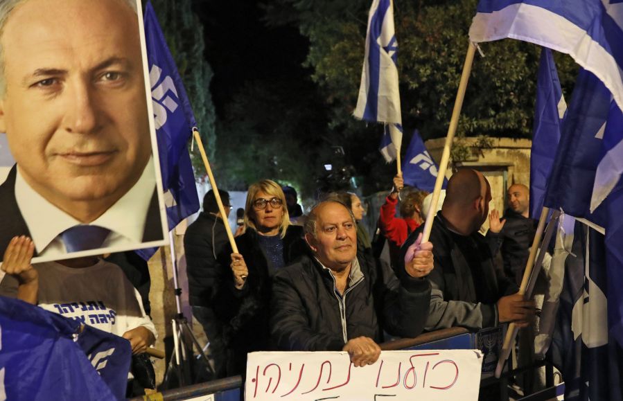 Supporters of Israeli Prime Minister Benjamin Netanyahu chant slogans as they demonstrate their solidarity with him outside his official residency in Jerusalem on Nov. 21, 2019. (Credit: GALI TIBBON/AFP via Getty Images)