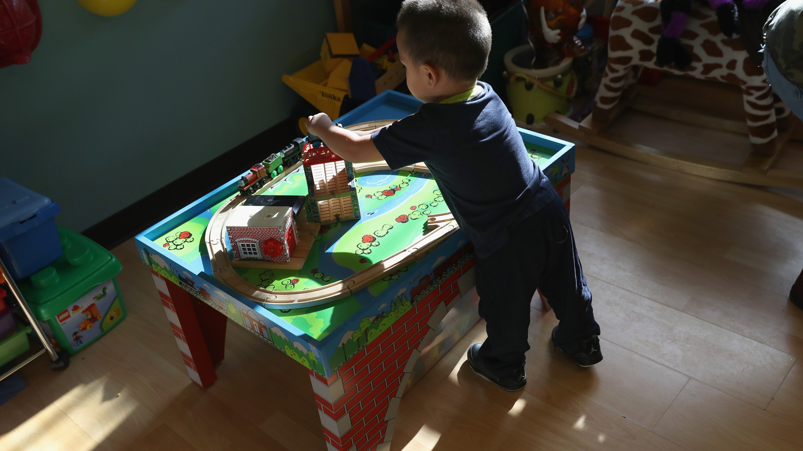 A boy plays in a childcare center as his mother takes part in a English-as-a-Second-Language (ESL), class on Dec. 3, 2016, at a migrants assistance center in Stamford, Conn. (Credit: John Moore/Getty Images)