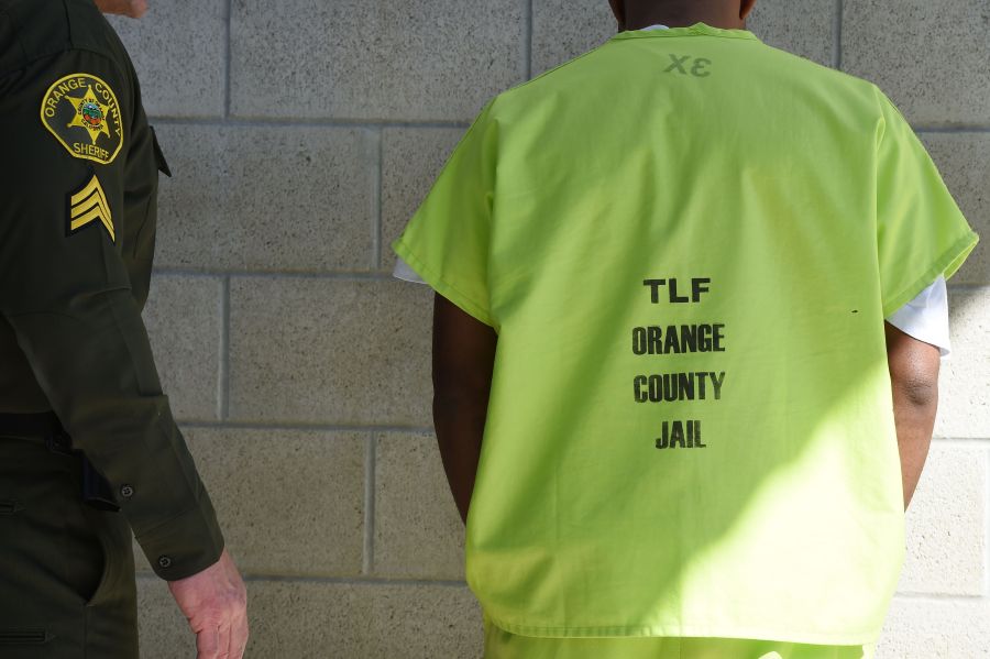 An Orange County Sheriff's Department deputy speaks to a detainee on March 14, 2017, in Orange. (Credit: Robyn Beck/AFP via Getty Images)