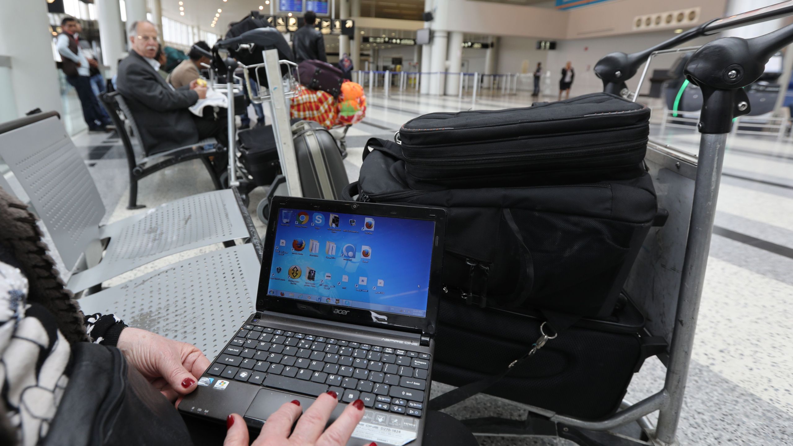 A Syrian woman travelling to the U.S. opens her laptop before checking in at Beirut international airport in Lebanon on March 22, 2017.(Credit: Anwar Amro / AFP / Getty Images)