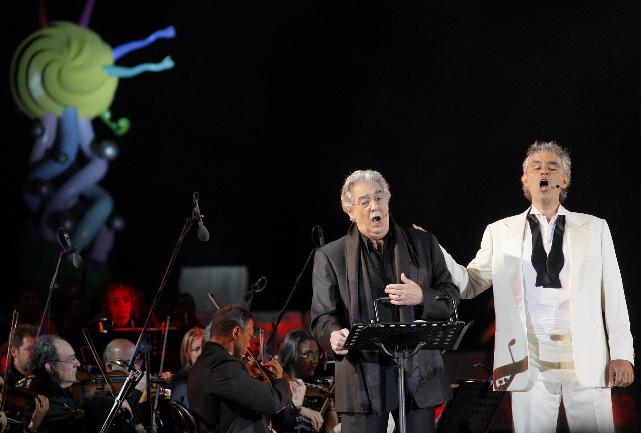 Andrea Bocelli and Placido Domingo sing during the annual concert at the Theatre of the Silence on July 18, 2009 in Lajatico a comune of Pisa. (Credit: FABIO MUZZI/AFP via Getty Images)