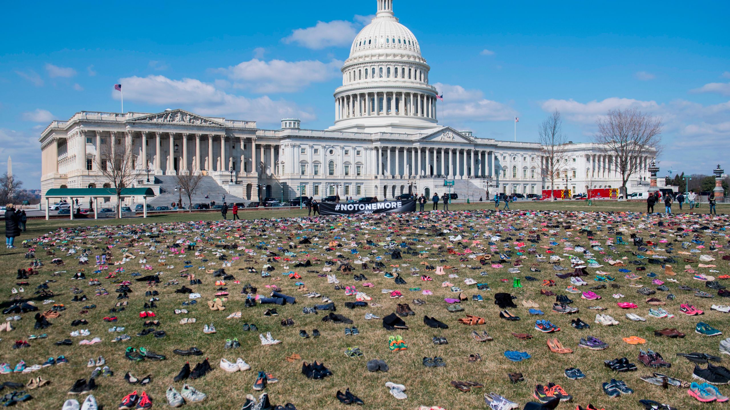 The lawn outside the U.S. Capitol is covered with 7,000 pairs of empty shoes to memorialize children killed by gun violence since the Sandy Hook school shooting on March 13, 2018. (Credit: Saul Loeb/AFP via Getty Images)