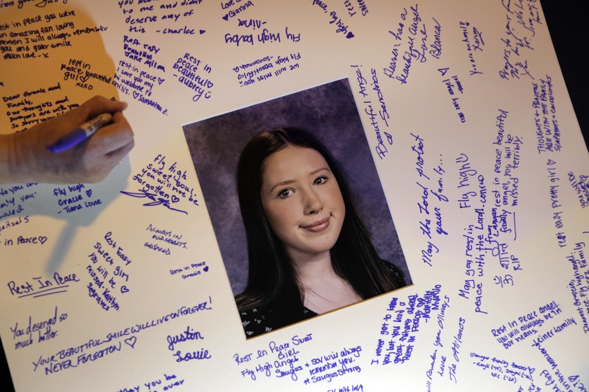 Students sign a card in memory of Gracie Anne Muehlberger, one of two students killed in the shooting on Nov. 14, 2019, at Saugus High School in Santa Clarita.(Credit: Carolyn Cole / Los Angeles Times)