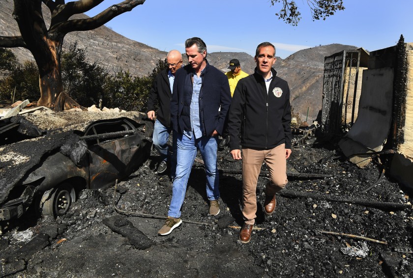 L.A. Councilman Mike Bonin, left, Gov. Gavin Newsom and L.A. Mayor Eric Garcetti look over fire devastation in Brentwood in the undated photo. (Credit: Wally Skalij/Los Angeles Times)