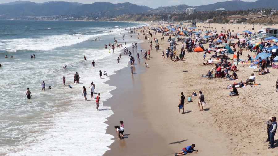 Tourists and Angelenos enjoy the beach in Santa Monica, California, on April 21, 2019. (DANIEL SLIM/AFP via Getty)