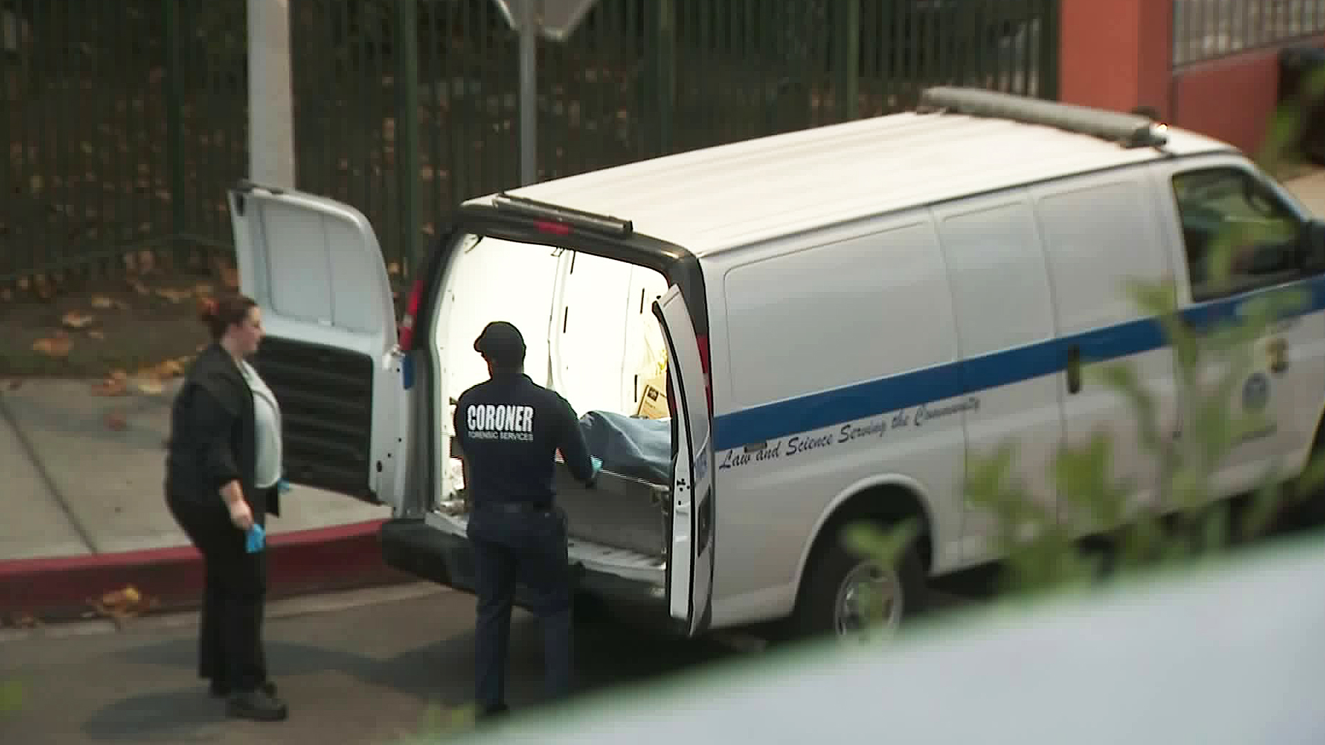 Coroner's officials remove a man's body in Cudahy on Dec. 9, 2019. (Credit: KTLA)