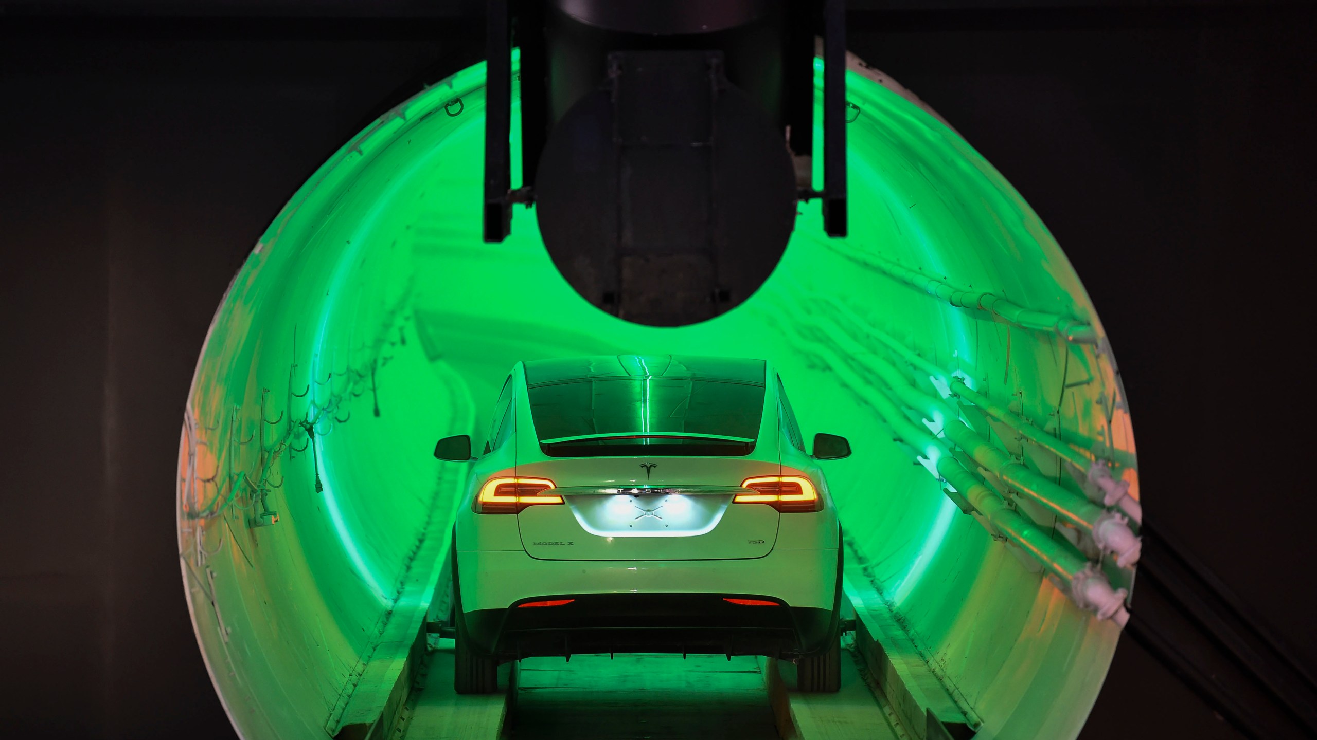 A modified Tesla Model X drives into the tunnel entrance before an unveiling event for the Boring Company Hawthorne test tunnel in Hawthorne, south of Los Angeles on Dec. 18, 2018. (Credit: ROBYN BECK/AFP via Getty Images)