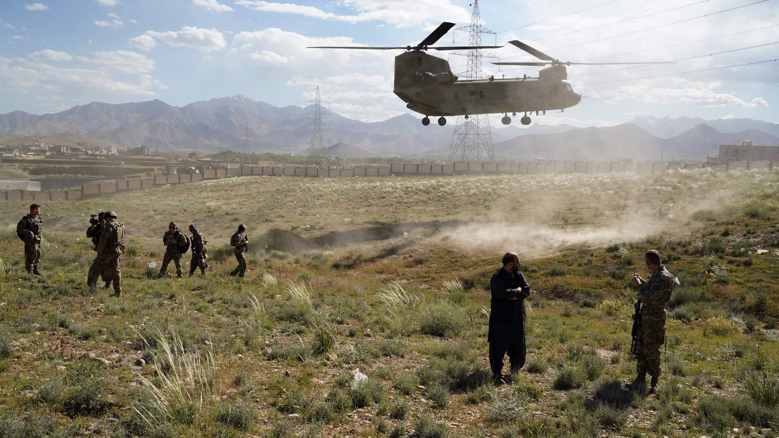 In this photo taken on June 6, 2019, a U.S. military Chinook helicopter lands on a field outside the governor's palace during a visit by the commander of U.S. and NATO forces in Afghanistan. (Credit: THOMAS WATKINS/AFP via Getty Images)