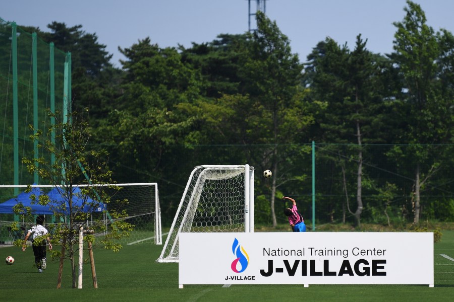 Children play football at the J-Village during a media tour in Naraha, Fukushima prefecture on August 2, 2019. (Credit: CHARLY TRIBALLEAU/AFP via Getty Images)