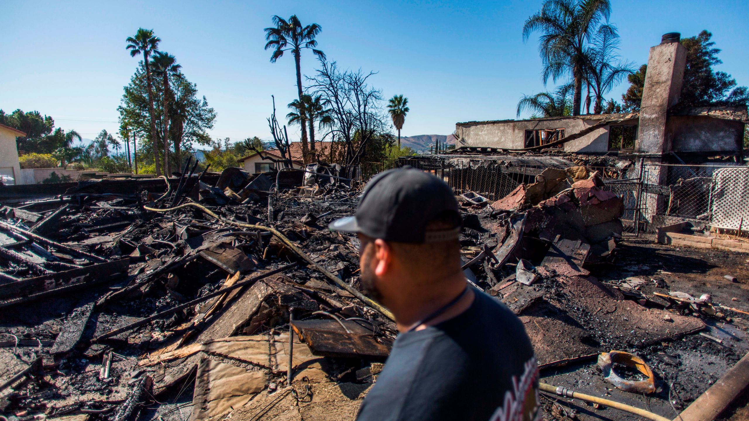 Matthew Valdivia looks at what is left of his home on Viento Way after it was destroyed by the Hillside Fire in San Bernardino, Oct. 31, 2019. (Credit: Apu Gomes / AFP / Getty Images)