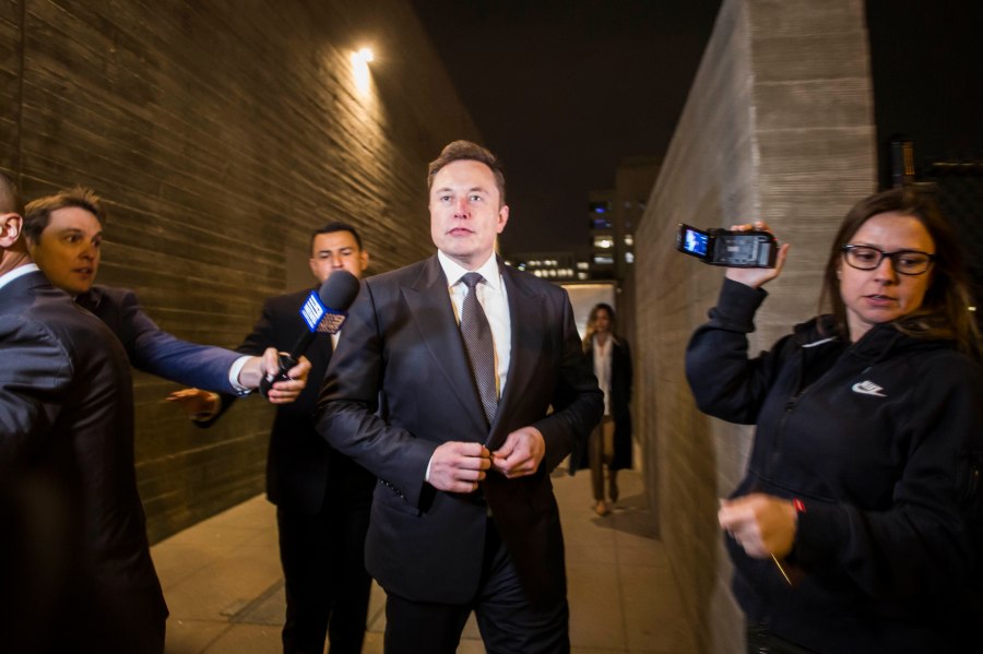 Elon Musk leaves a federal courthouse in Los Angeles through a back door on Dec. 3, 2019. (Credit: Apu Gomes / Getty Images)