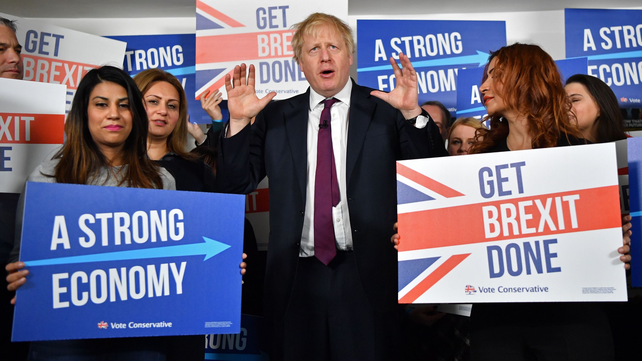 Britain's Prime Minister Boris Johnson speaks to activists and supporters as he poses for a photograph at the Conservative Campaign Headquarters Call Centre in central London on Dec. 8, 2019. (Credit: BEN STANSALL/POOL/AFP via Getty Images)