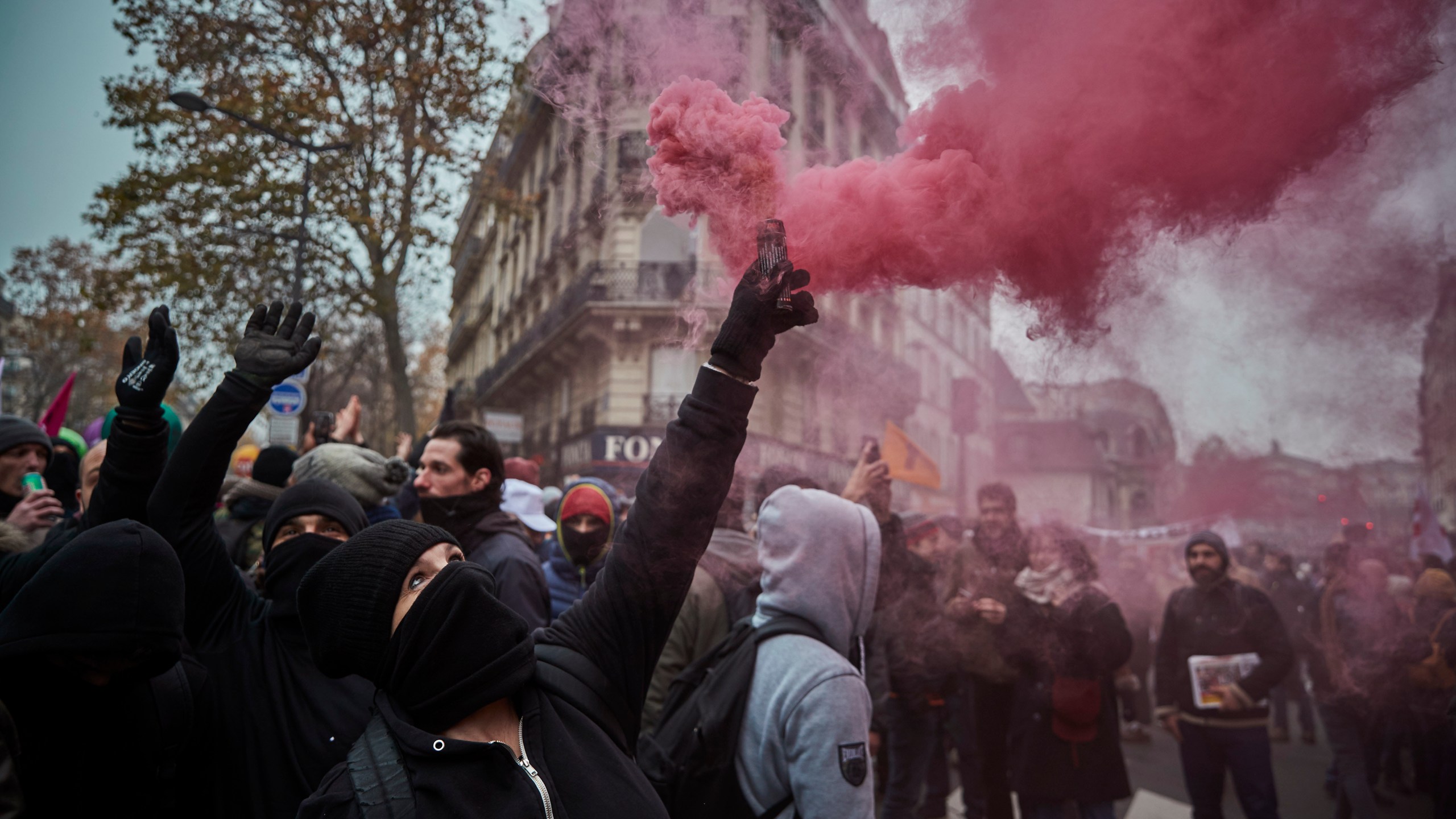 Protestors wave colored flares during a rally near Place de Republique in support of the national strike in France, one of the largest nationwide strikes in years, on Dec. 5, 2019 in Paris, France. (Credit: Kiran Ridley/Getty Images)