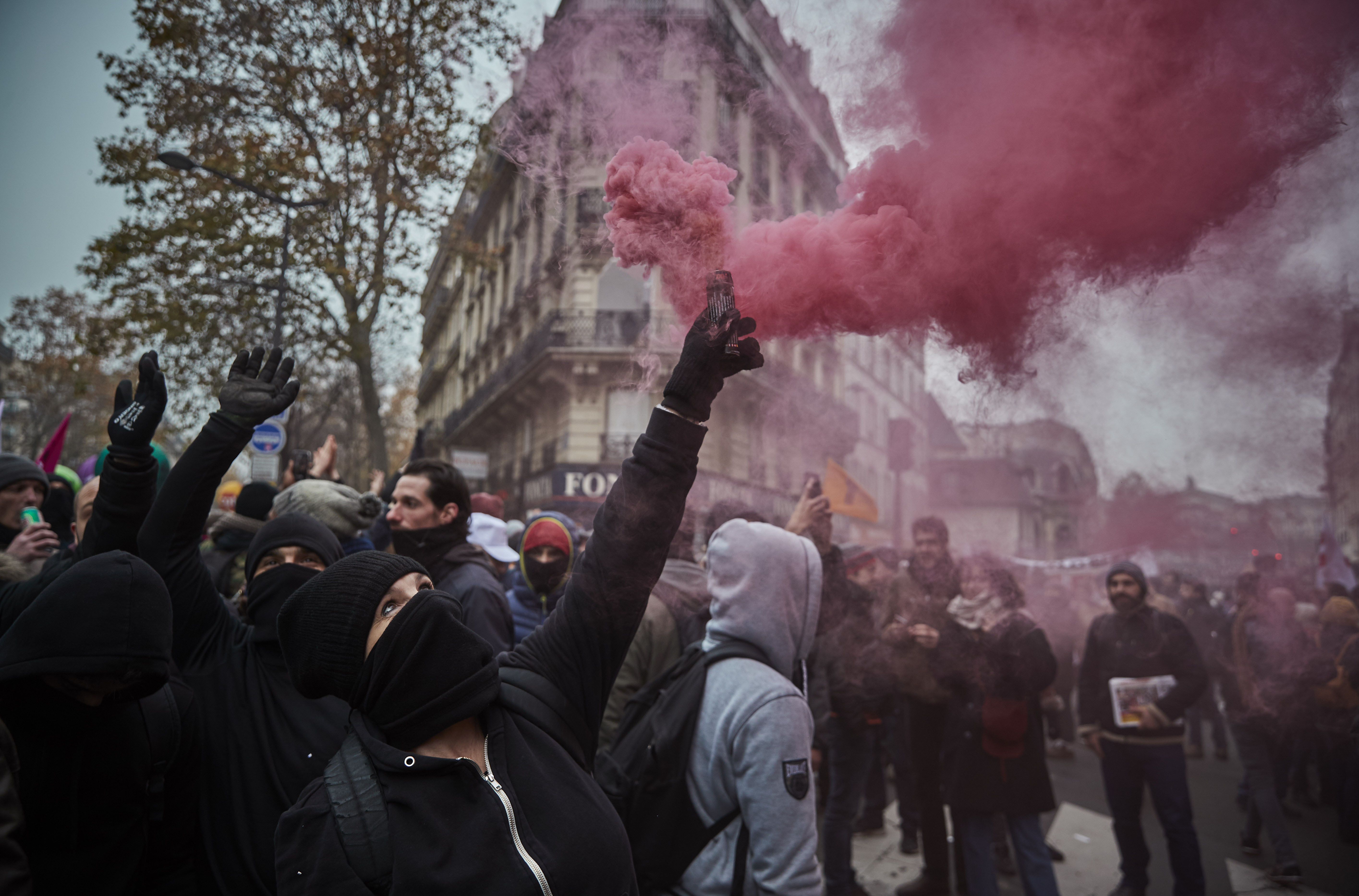 Protestors wave colored flares during a rally near Place de Republique in support of the national strike in France, one of the largest nationwide strikes in years, on Dec. 5, 2019 in Paris, France. (Credit: Kiran Ridley/Getty Images)