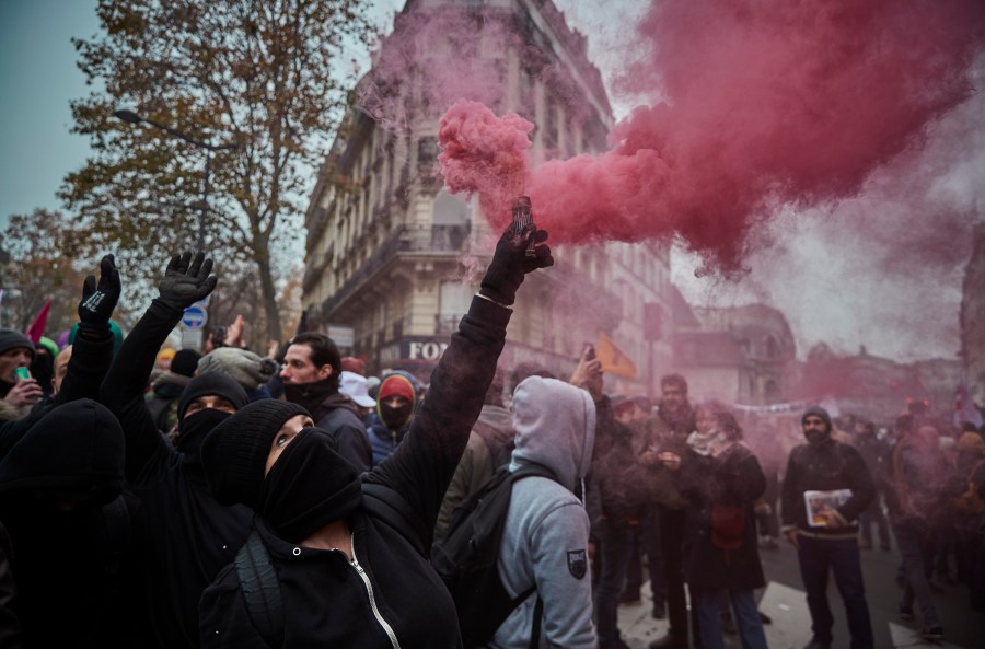 Protestors wave colored flares during a rally near Place de Republique in support of the national strike in France, one of the largest nationwide strikes in years, on Dec. 5, 2019 in Paris, France. (Credit: Kiran Ridley/Getty Images)