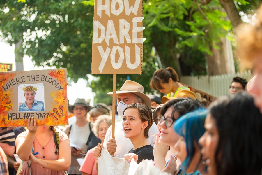 Protestors hold up banners during a protest at Kirribilli House on Dec. 19, 2019 in Sydney, Australia. Protestors organized the rally outside Prime Minister Scott Morrison's Sydney residence over his absence during the ongoing bushfire emergencies across Australia. (Credit: Jenny Evans/Getty Images)