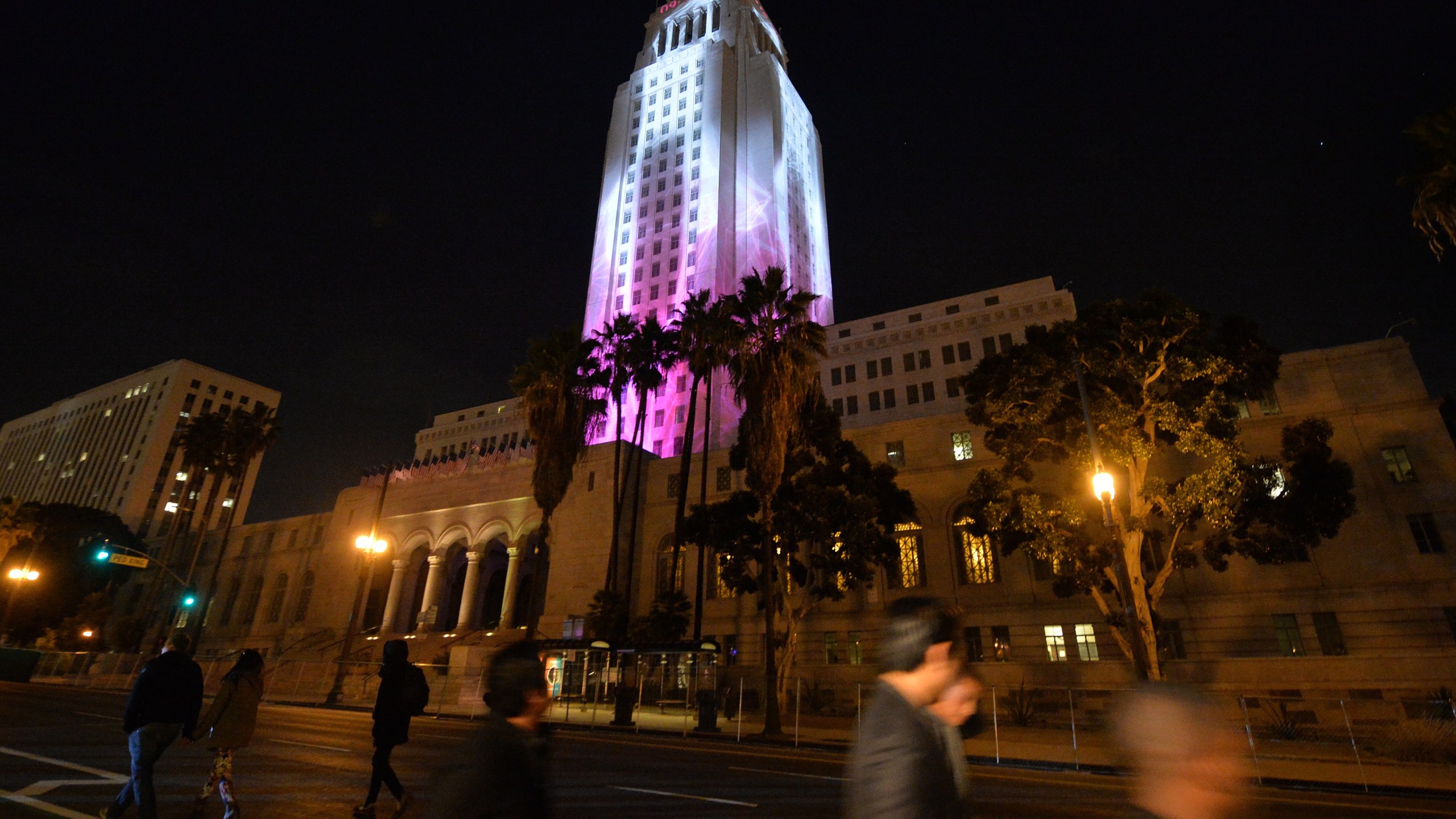 City Hall is lit by two dimensional projected images while people celebrate the New Year at the Grand Park's N.Y.E.L.A. event in downtown Los Angeles on December 31, 2014. (Credit: MARK RALSTON/AFP via Getty Images)