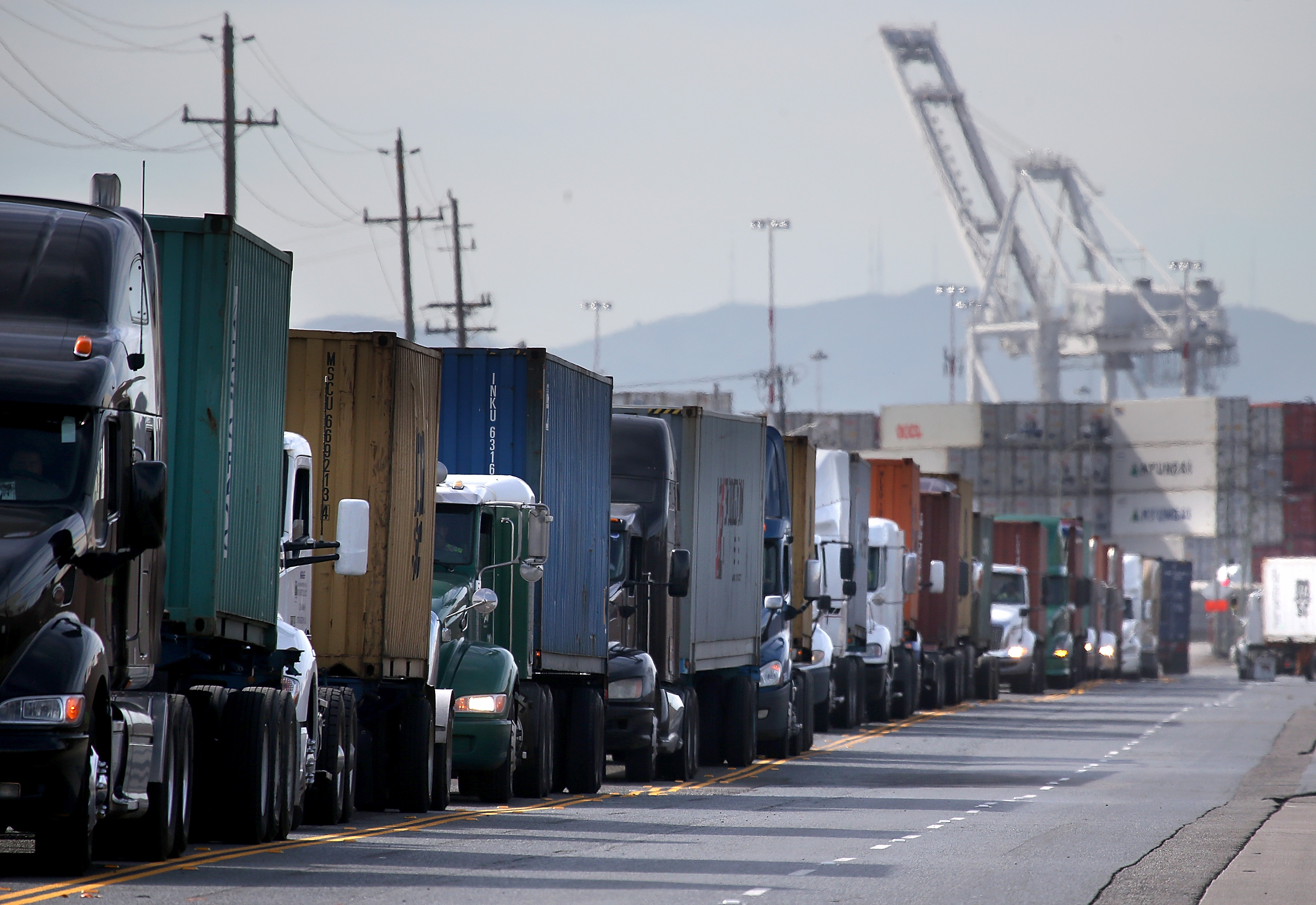 Trucks line up to enter a berth at the Port of Oakland on Feb. 11, 2015. (Credit: Justin Sullivan / Getty Images)