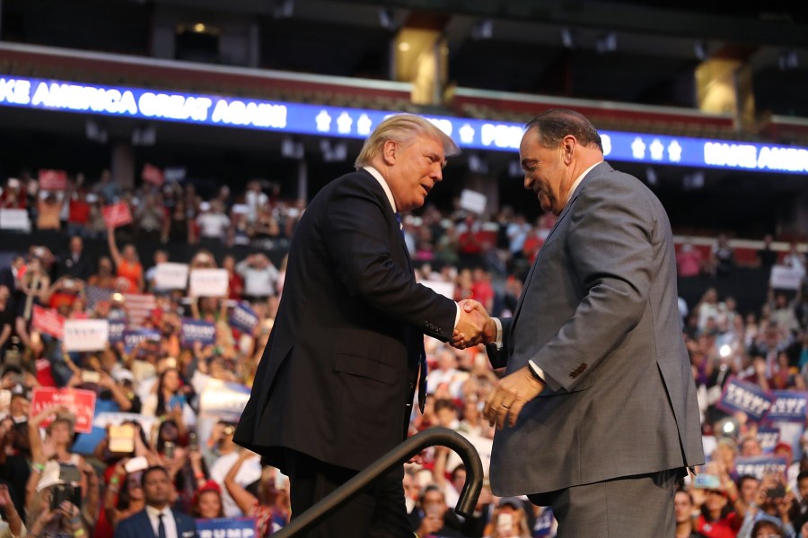 Donald Trump is greeted by former Arkansas Gov. Mike Huckabee during a campaign event at the BB&T Center on Aug. 10, 2016 in Fort Lauderdale, Florida. (Credit: Joe Raedle/Getty Images)