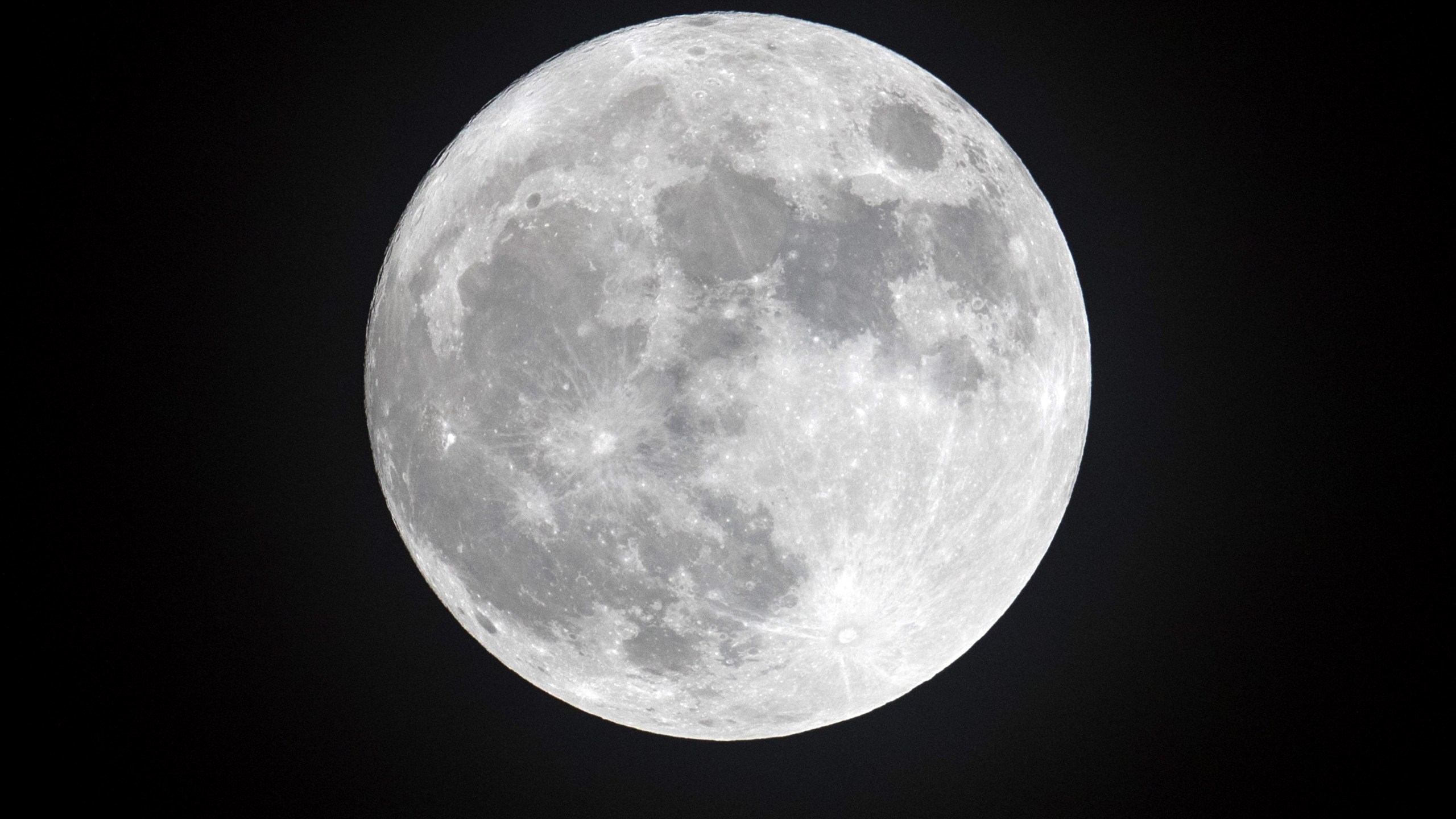 Clouds clear to allow a view of the final full moon of the year, a so-called 'cold moon', as it appears behind lights illuminating Penzance seafront on Dec.13, 2016, in Cornwall, England (Credit: Matt Cardy/Getty Images)