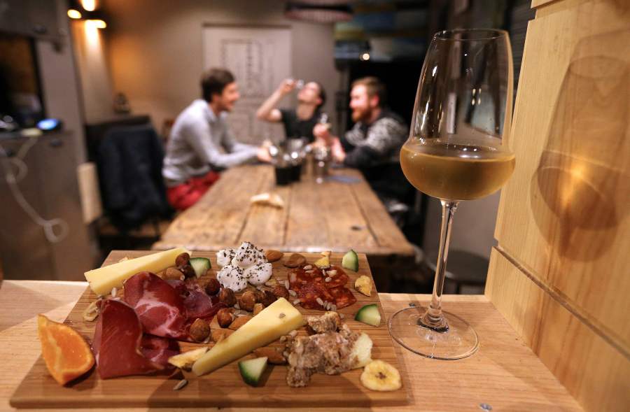 A glass of champagne is served with cheese and ham in Reims, northeastern France, on Dec. 20, 2016. (Credit: FRANCOIS NASCIMBENI/AFP via Getty Images)