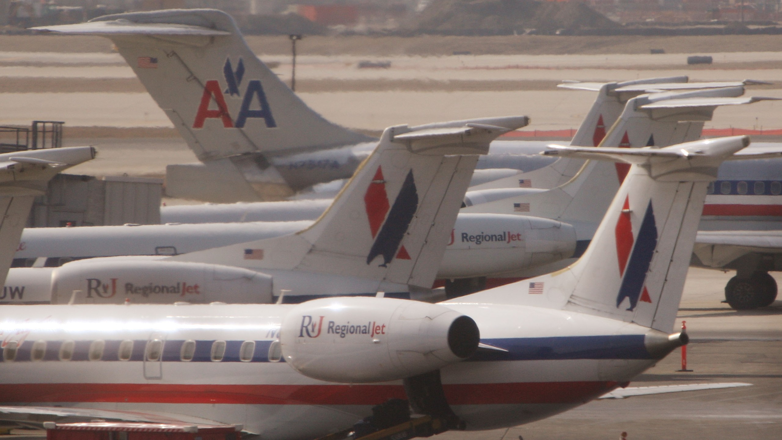 An American Airlines jet taxis past American Eagle jets in a March 2008 file photo. (Credit: Scott Olson/Getty Images)