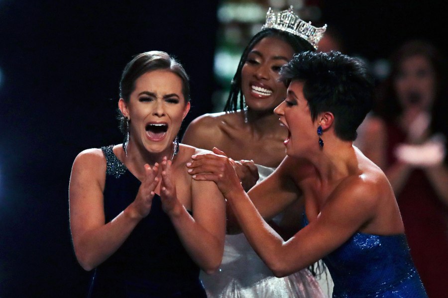 Camille Schrier, of Virginia, left, reacts after winning the Miss America competition at the Mohegan Sun casino in Uncasville, Conn., Thursday, Dec. 19, 2019. At right is runner-up Miss. Georgia Victoria Hill and and at rear is 2019 Miss. America Nia Franklin. (AP Photo/Charles Krupa, via CNN)