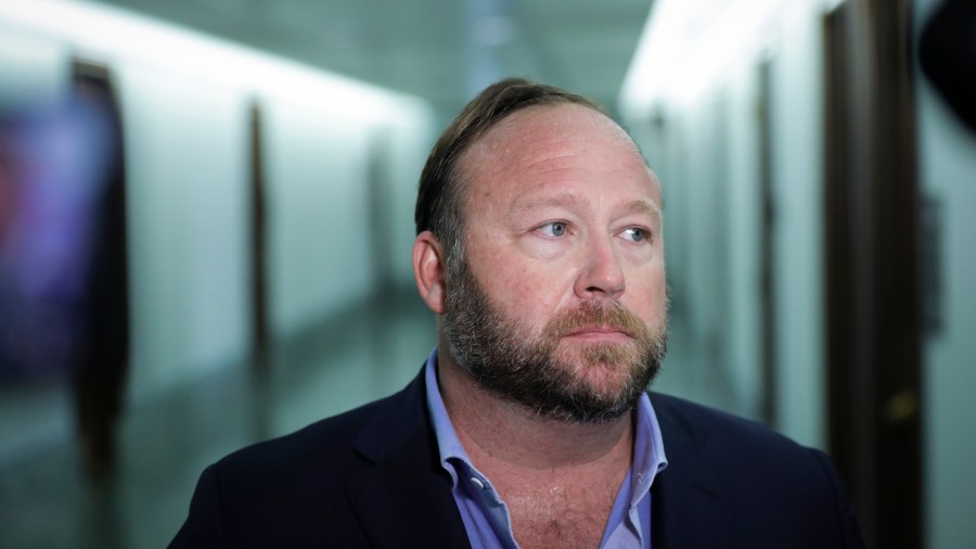 Alex Jones of InfoWars talks to reporters outside a Senate Intelligence Committee hearing concerning foreign influence operations' use of social media platforms, on Capitol Hill on Sept. 5, 2018. (Credit: Drew Angerer/Getty Images)