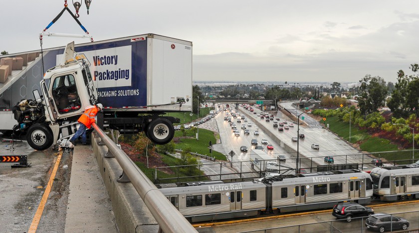 A big rig hangs over a ramp connecting the 710 and 60 freeways in East Los Angeles amid rain on Dec. 4, 2019. (Credit: Irfan Khan/Los Angeles Times)