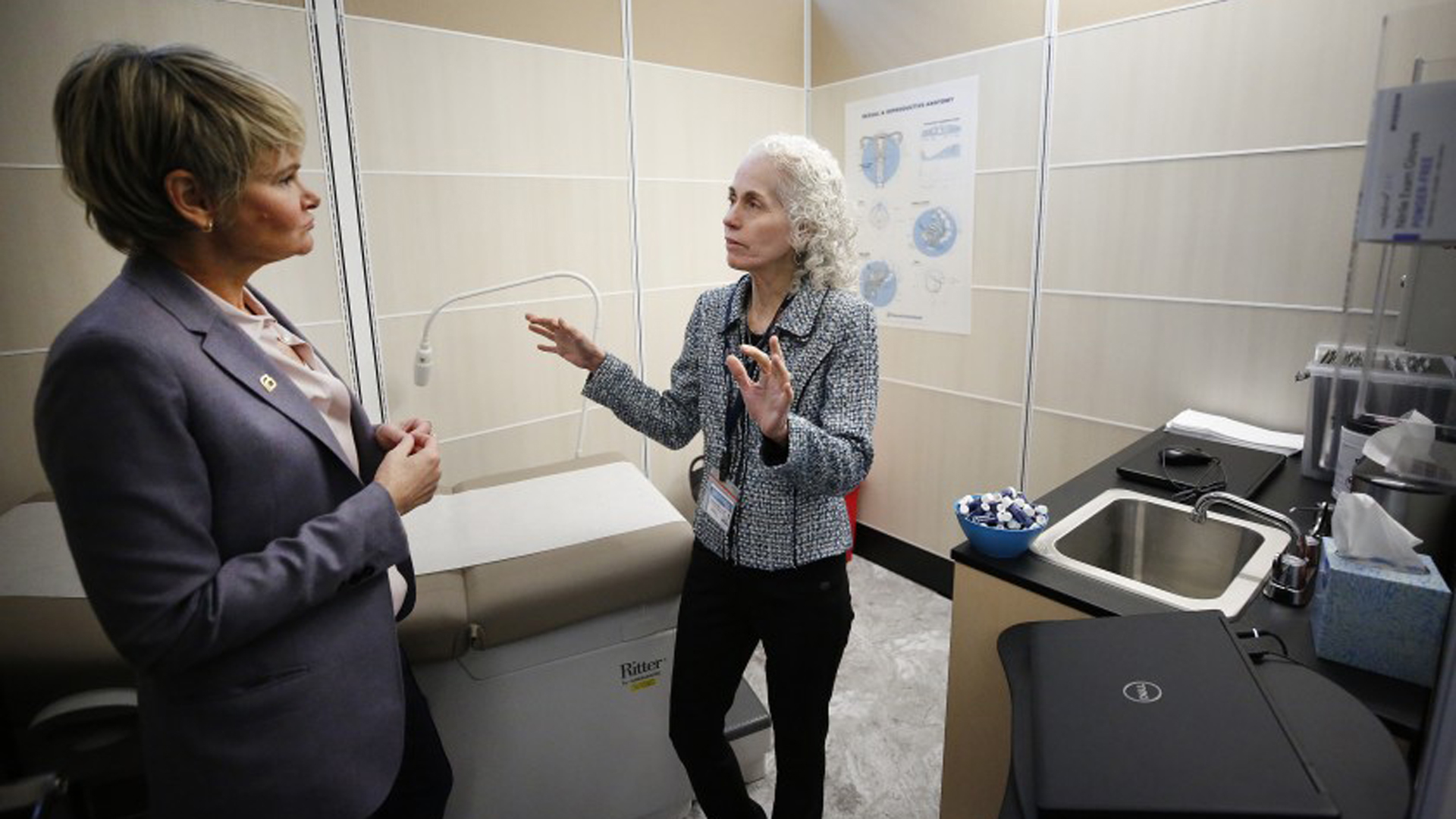 Sue Dunlap, left, president and CEO of Planned Parenthood Los Angeles, talks with Barbara Ferrer, the L.A. County public health director, as they tour the new sexual healthcare center at Esteban Torres High School in East L.A.(Credit: Al Seib / Los Angeles Times)