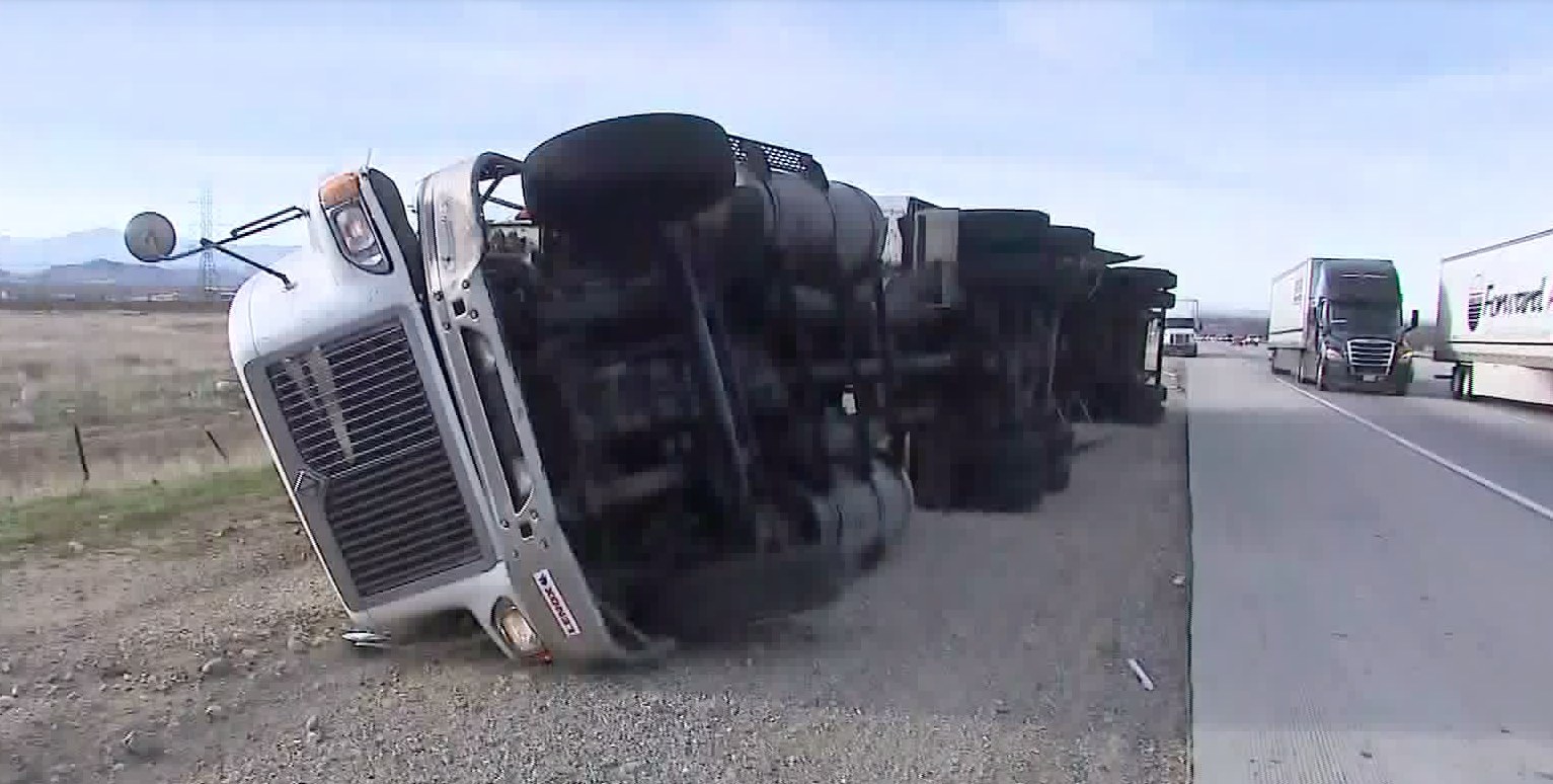 The powerful Santa Ana winds knocked over a big rig on the northbound 15 Freeway in Fontana on Dec. 17, 2019. (Credit: KTLA)