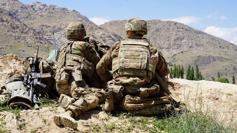 In this photo taken on June 6, 2019, U.S. soldiers look out over hillsides during a visit of the commander of U.S. and NATO forces in Afghanistan General Scott Miller at the Afghan National Army checkpoint in Nerkh district of Wardak province. (Credit: THOMAS WATKINS/AFP via Getty Images)