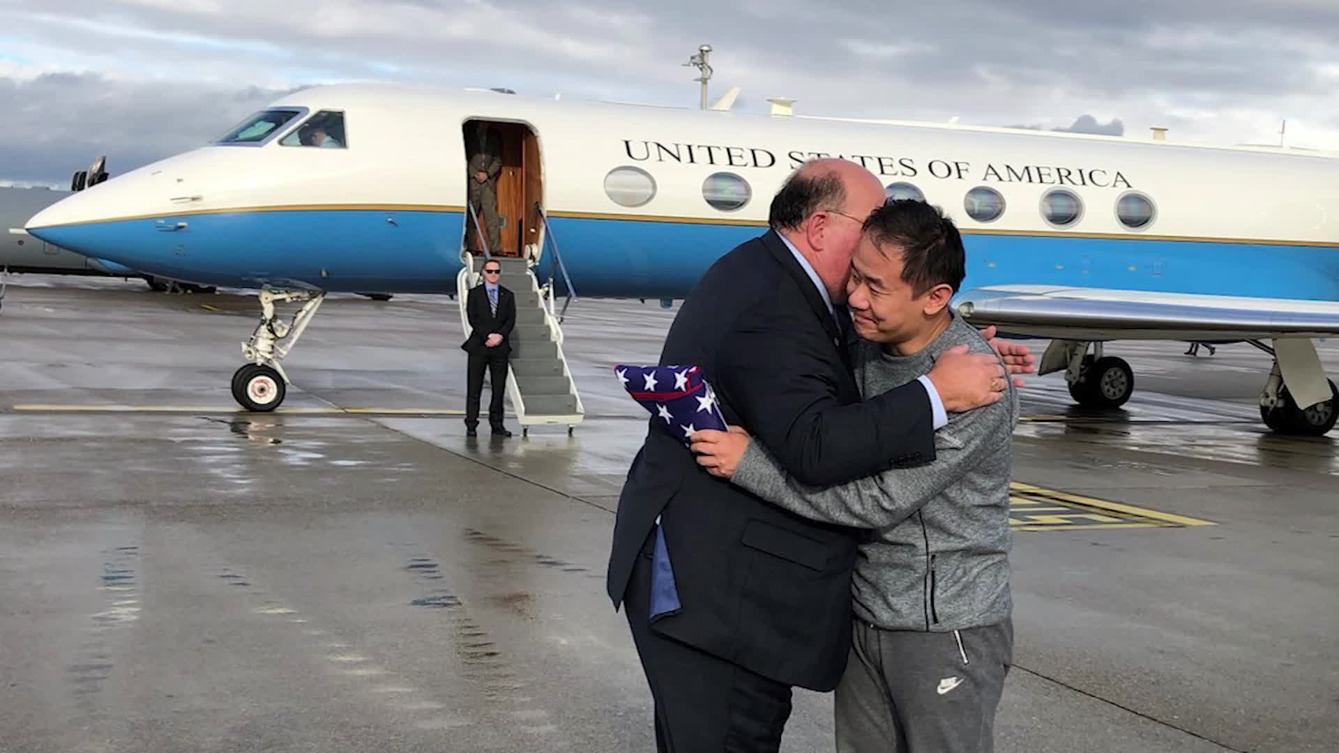 Chinese-American graduate student Xiyue Wang, detained for years on suspicion of being a spy, hugs an official after being freed from Iran on Dec. 7, 2019. (Credit: CNN)