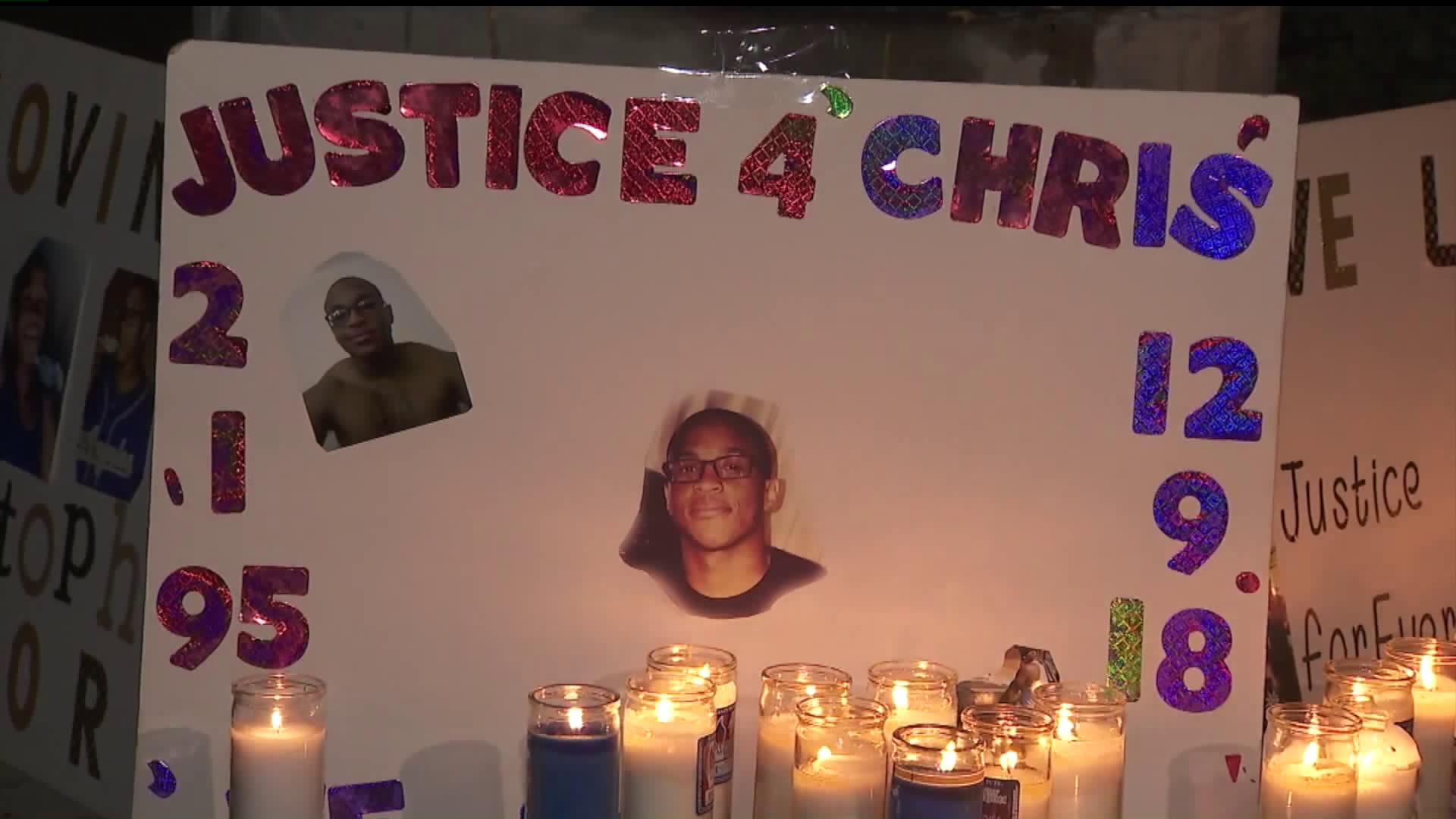 A sign is displayed during a vigil held Dec. 9, 2019, one year after Christopher Mitchell was shot and killed by Torrance police. (Credit: KTLA)