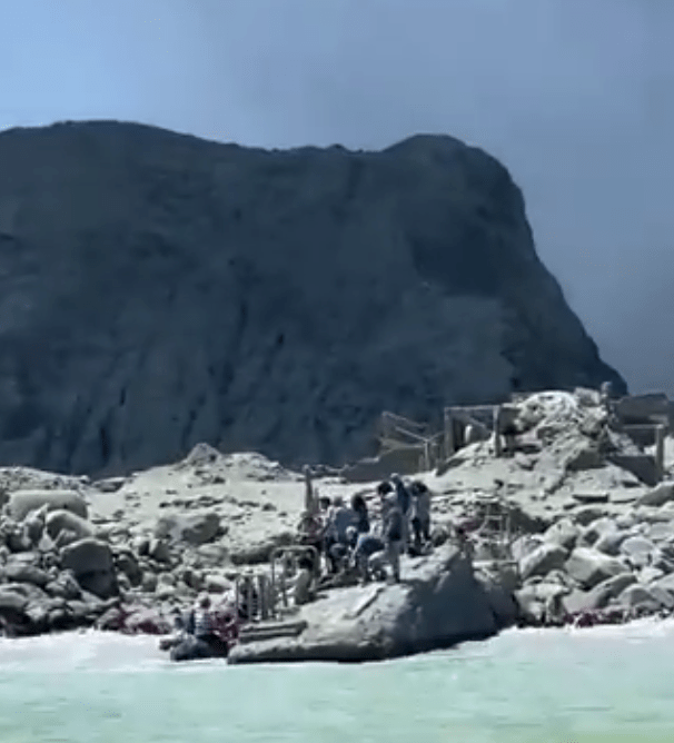 People are seen seeking refuge on the beach during a volcanic eruption on New Zealand's White Island on Dec. 9, 2019. (Credit: @sch on Twitter)