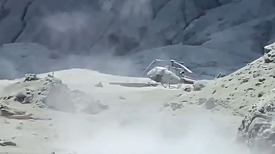 An image of a damaged helicopter on White Island after the eruption. (Credit: Twitter/Michael Schade via CNN)