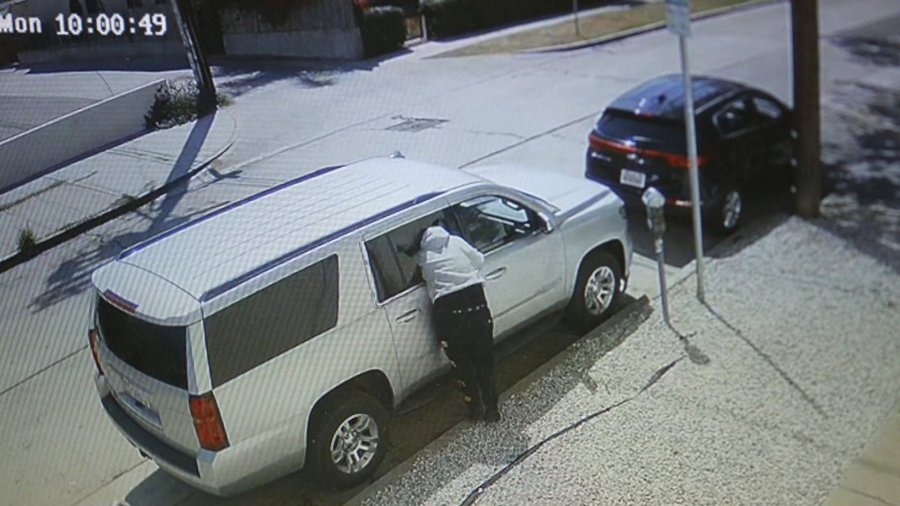 A person burglarizes a vehicle in broad daylight and is caught on video at La Jolla and Melrose avenues in Los Angeles.(Credit: Genaro Molina / Los Angeles Times)