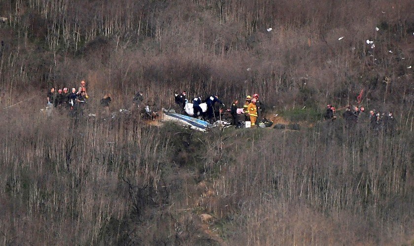 Officials assess the wreckage of the helicopter crash that killed Kobe Bryant, his 13-year-old daughter Gigi and seven others on Jan. 26, 2020 in Calabasas. (Credit: Christina House / Los Angeles Times)